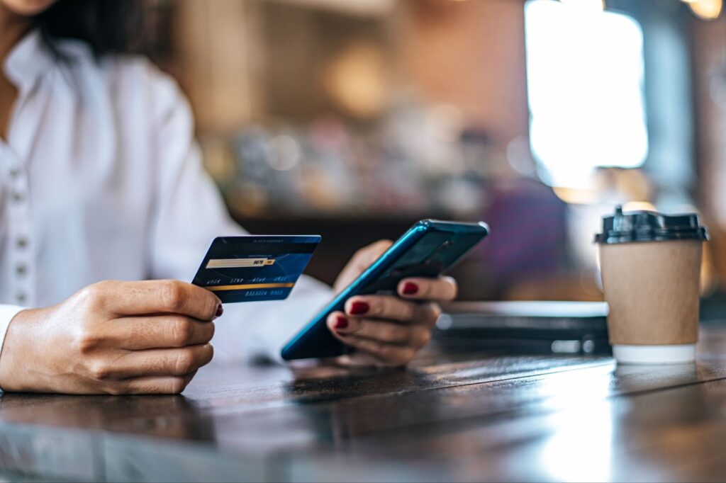 Close up of man holding his card and phone