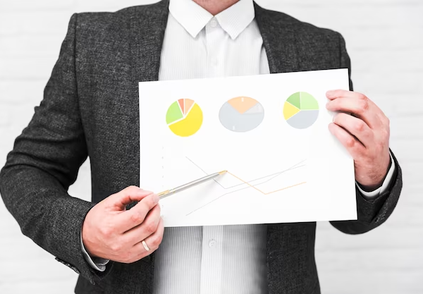 A man holding charts for financial analysis