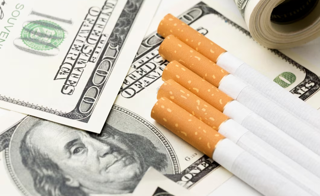 Cigarettes surrounded by dollar bills