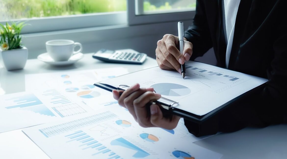 A man in an office holding a pan and a chart