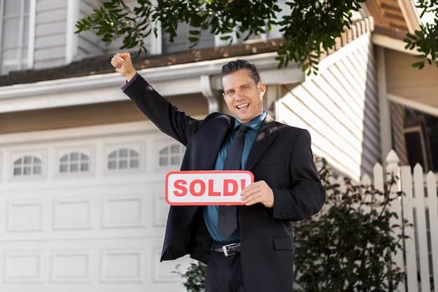 Man holding a Sold sign in front of the house